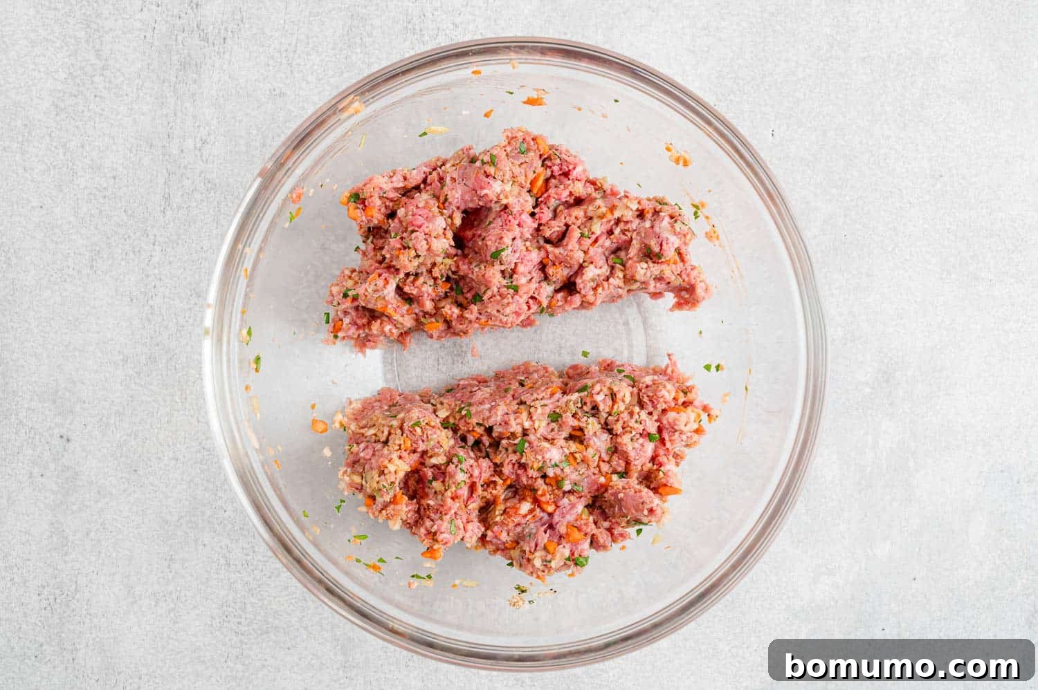 The meatloaf mixture divided into two distinct portions, ready for shaping.