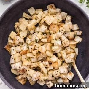 Roasted turnips in a large black bowl.