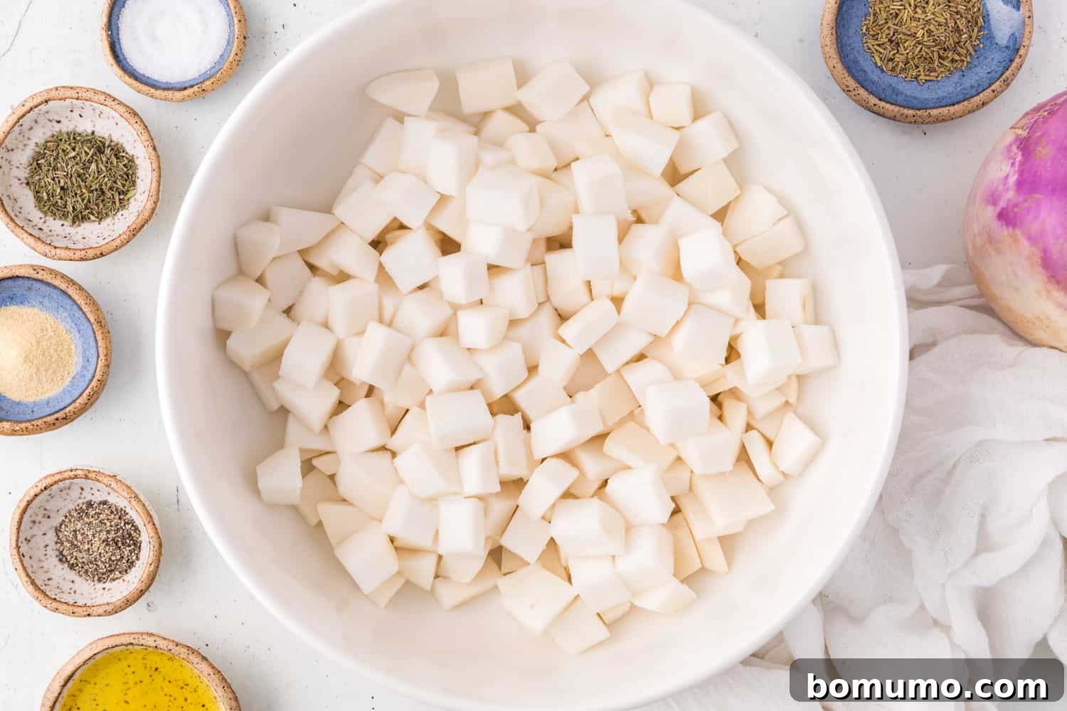 Cut turnips in a mixing bowl, unseasoned.