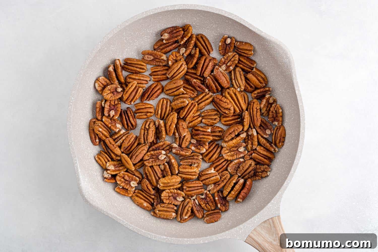 Best Spiced Pecans Ever 6 Pecans in a pan, toasting to perfection.