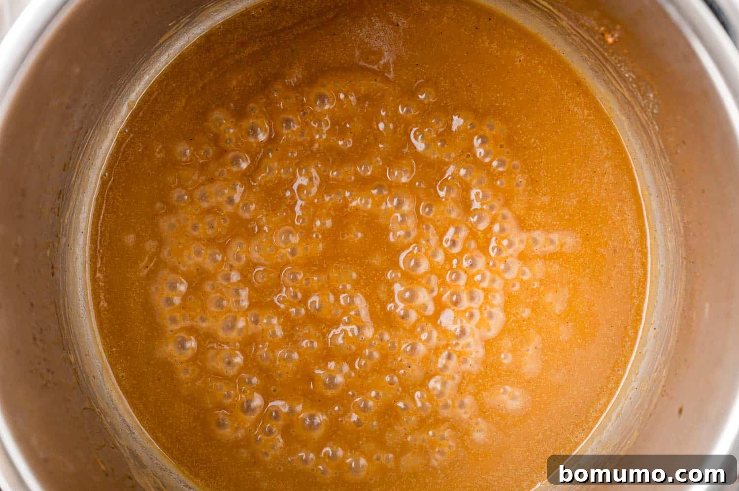 Chicken gravy in the Instant Pot, light brown in color.