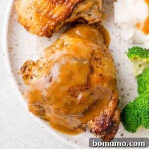 Instant pot chicken thighs on a plate with broccoli and mashed potatoes.