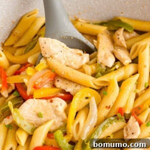Rasta past in pan - penne pasta, peppers, and spices.