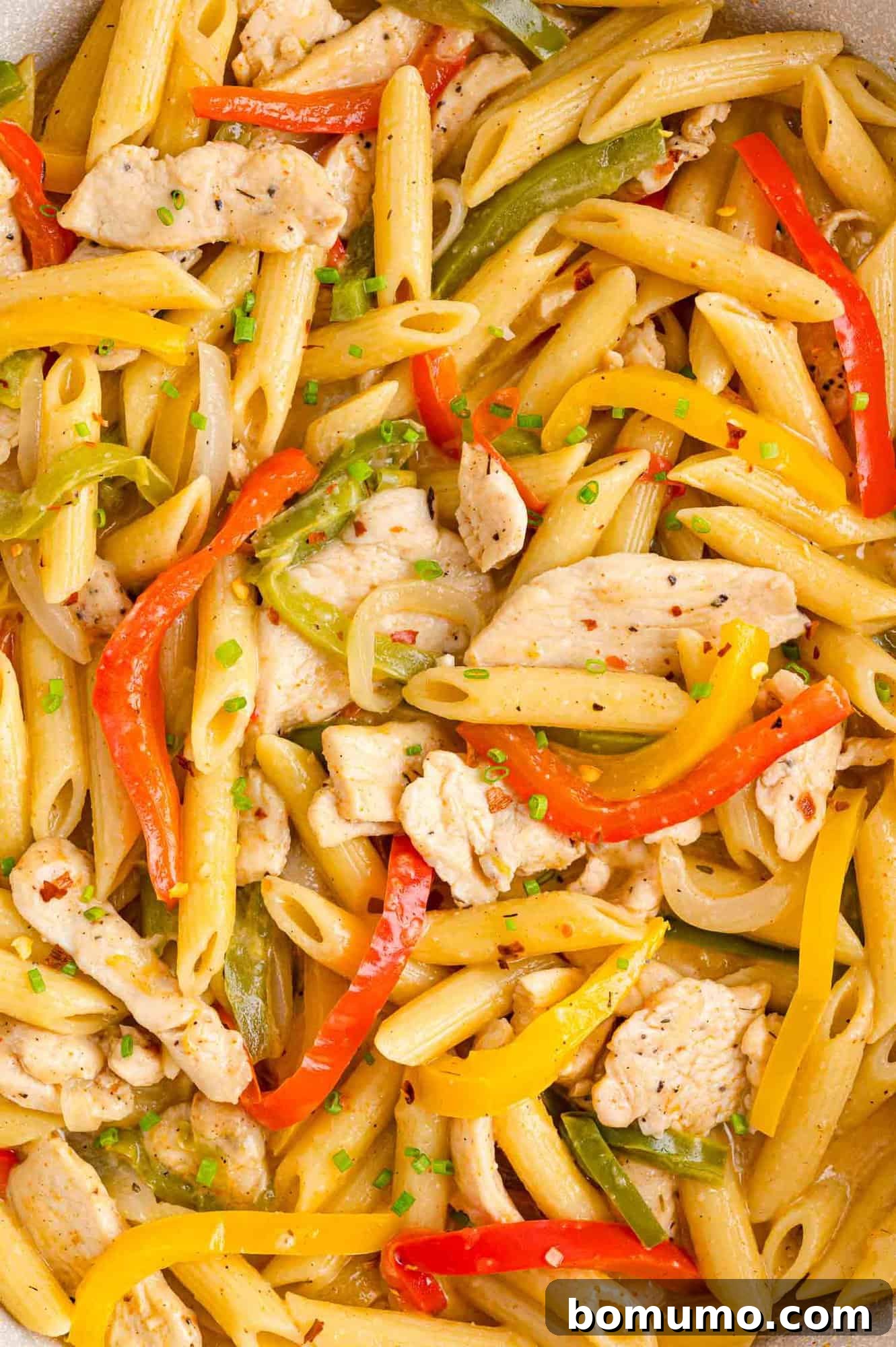 Close up of Rasta Pasta with chicken, bell peppers, and onions.