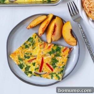 Sheet pan eggs served on a plate with fresh peaches.