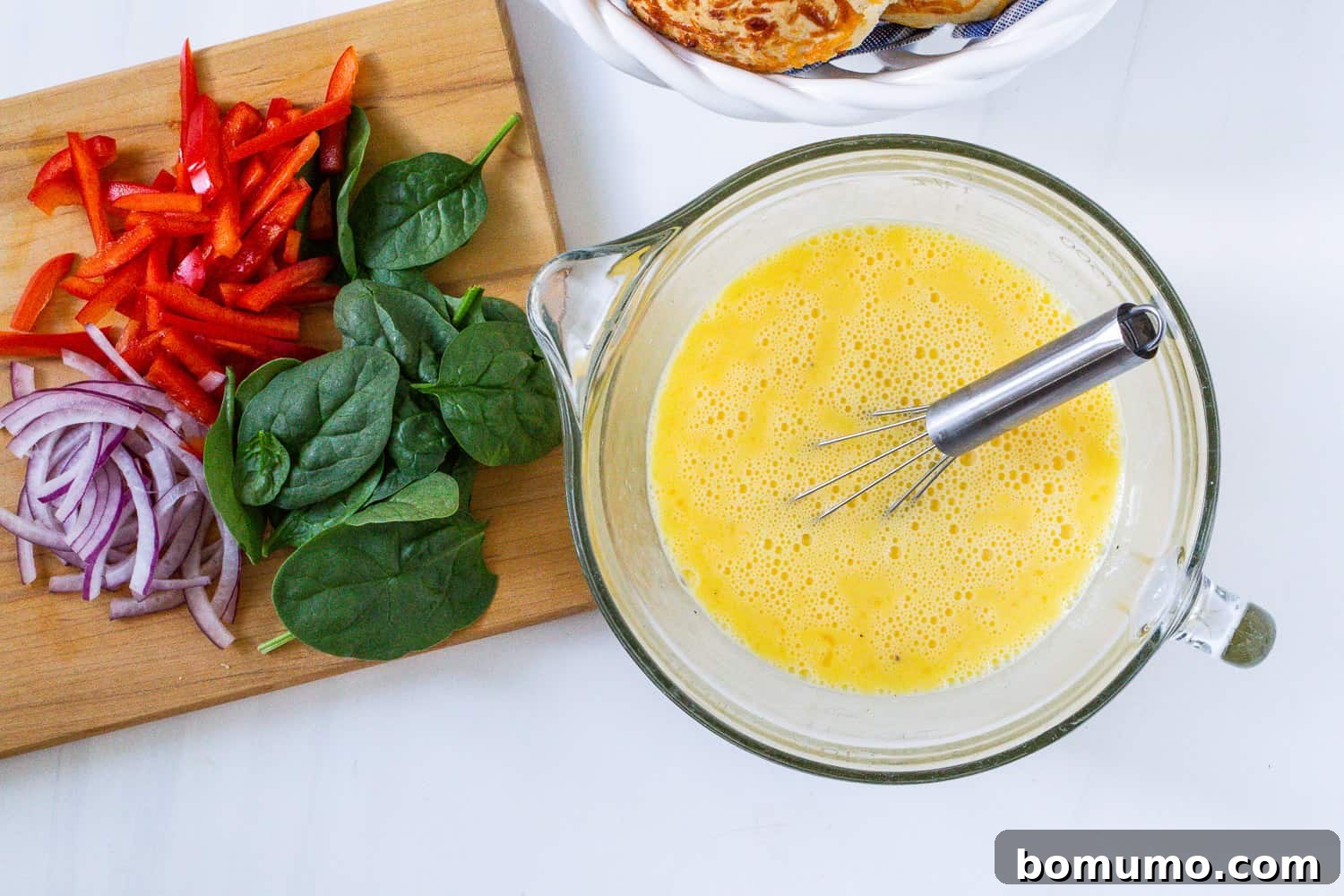 Smooth, well-whisked egg and milk mixture in a mixing bowl, ready for pouring.