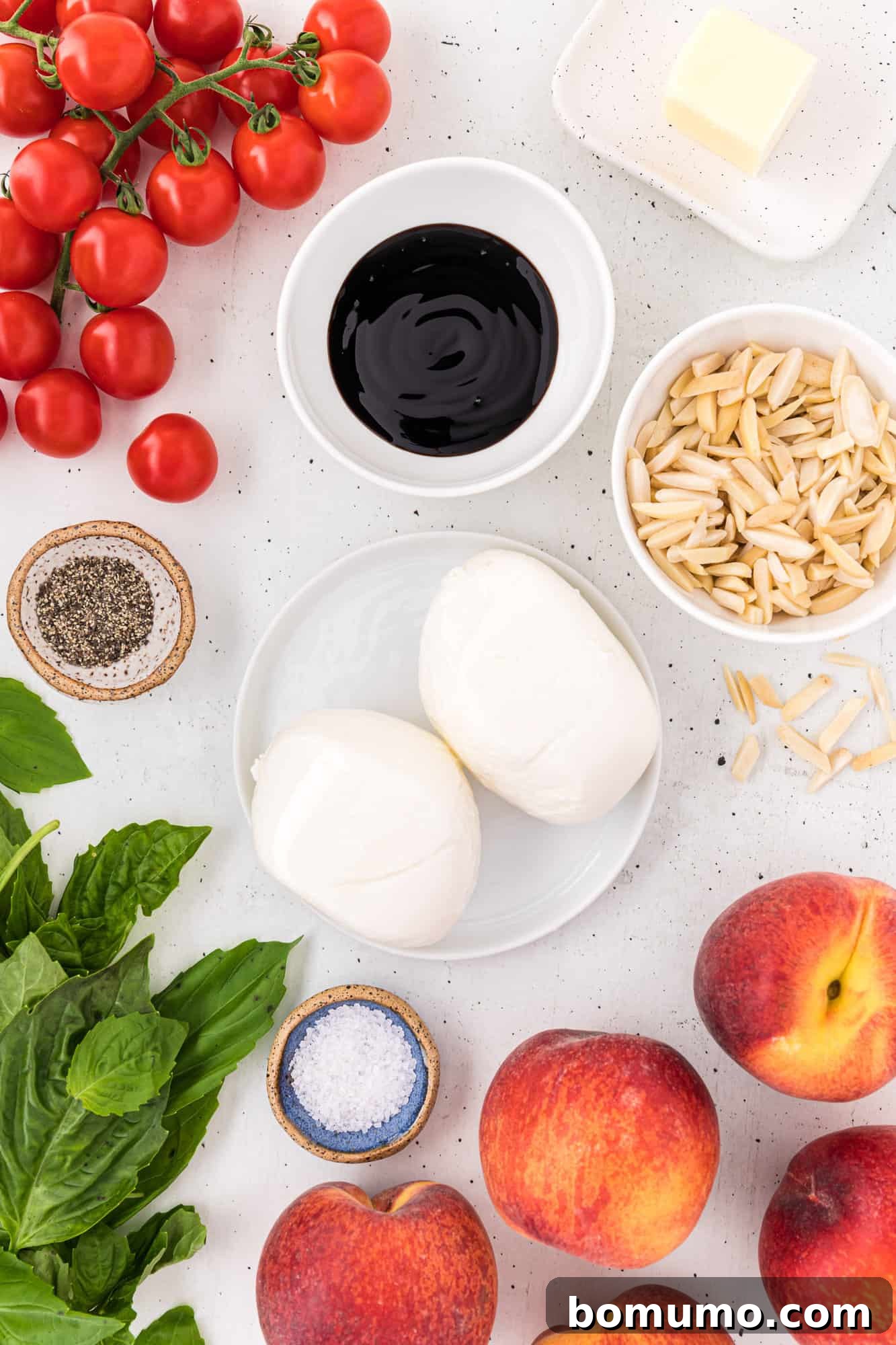A vibrant selection of fresh ingredients for the grilled peach and burrata salad, including ripe peaches, aromatic basil, and creamy burrata cheese.