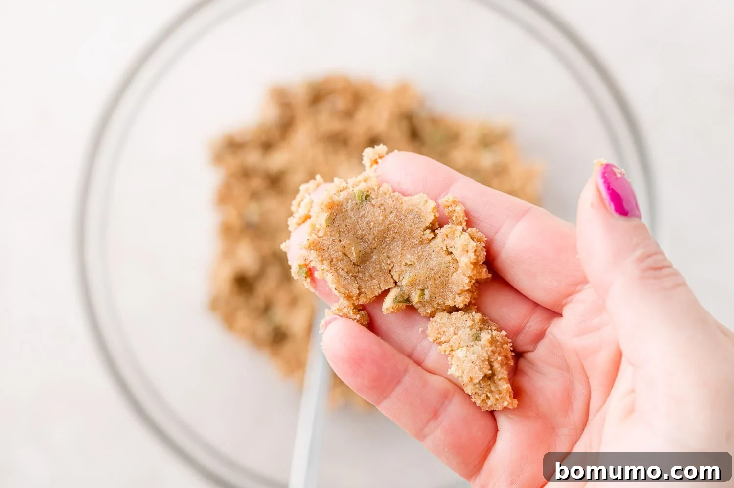 Streusel held in hand to show texture.