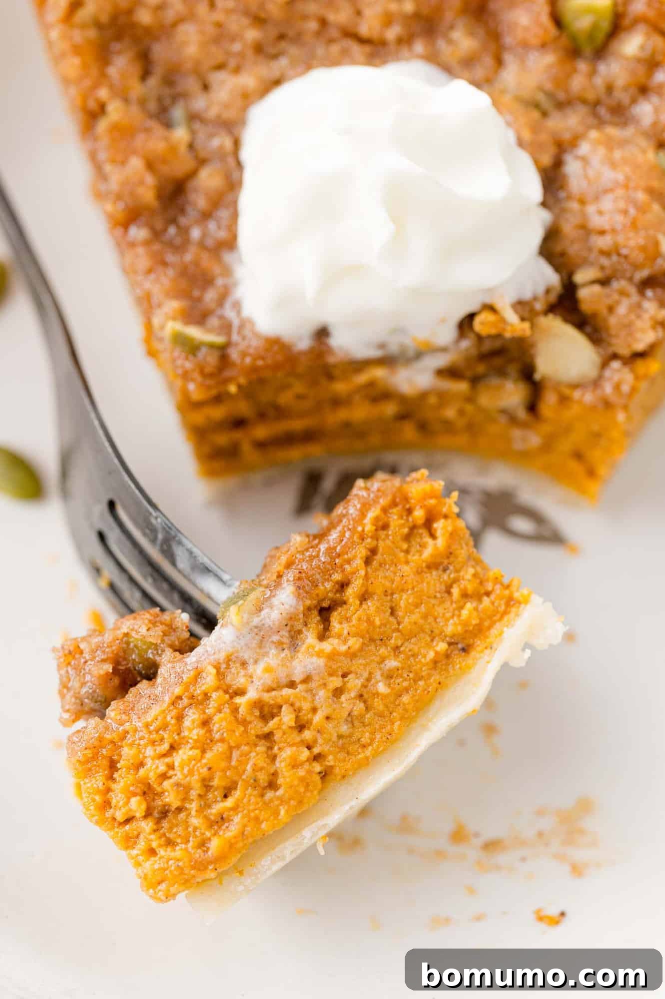 Bite of pumpkin streusel pie on a for.