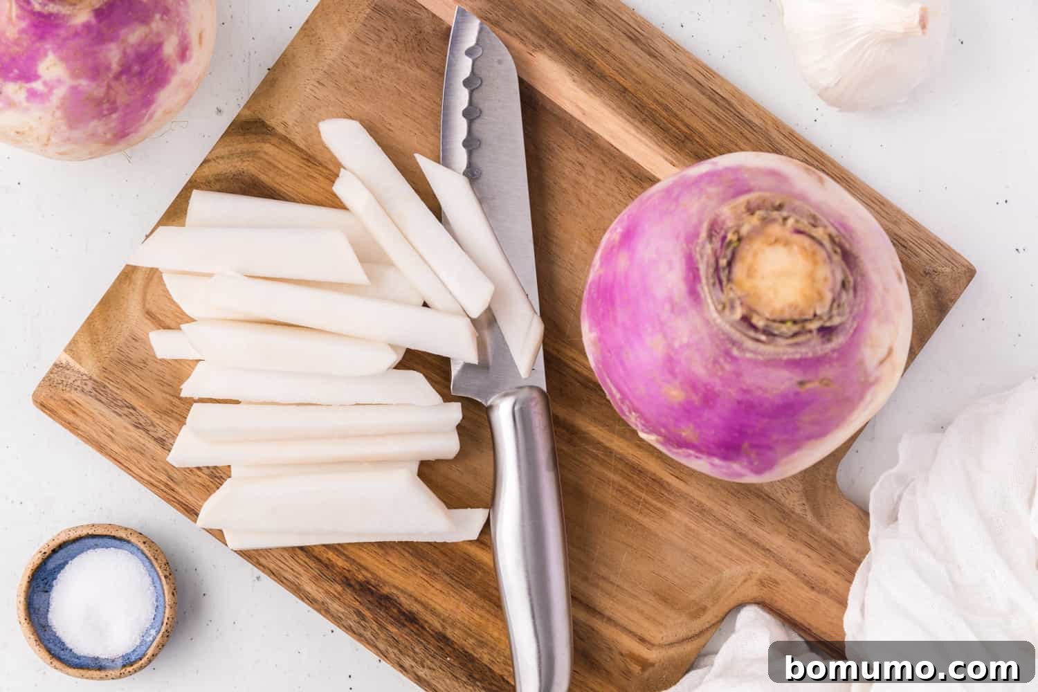 Turnip being peeled and sliced.