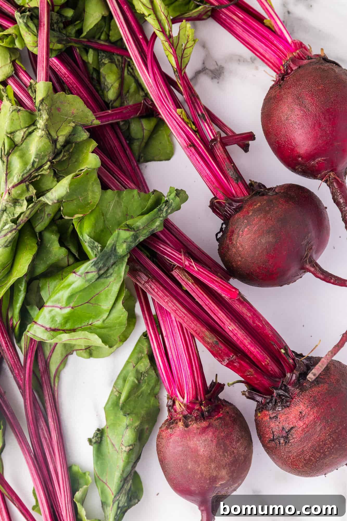 Freshly harvested beets with their green tops still attached, showcasing their natural beauty.