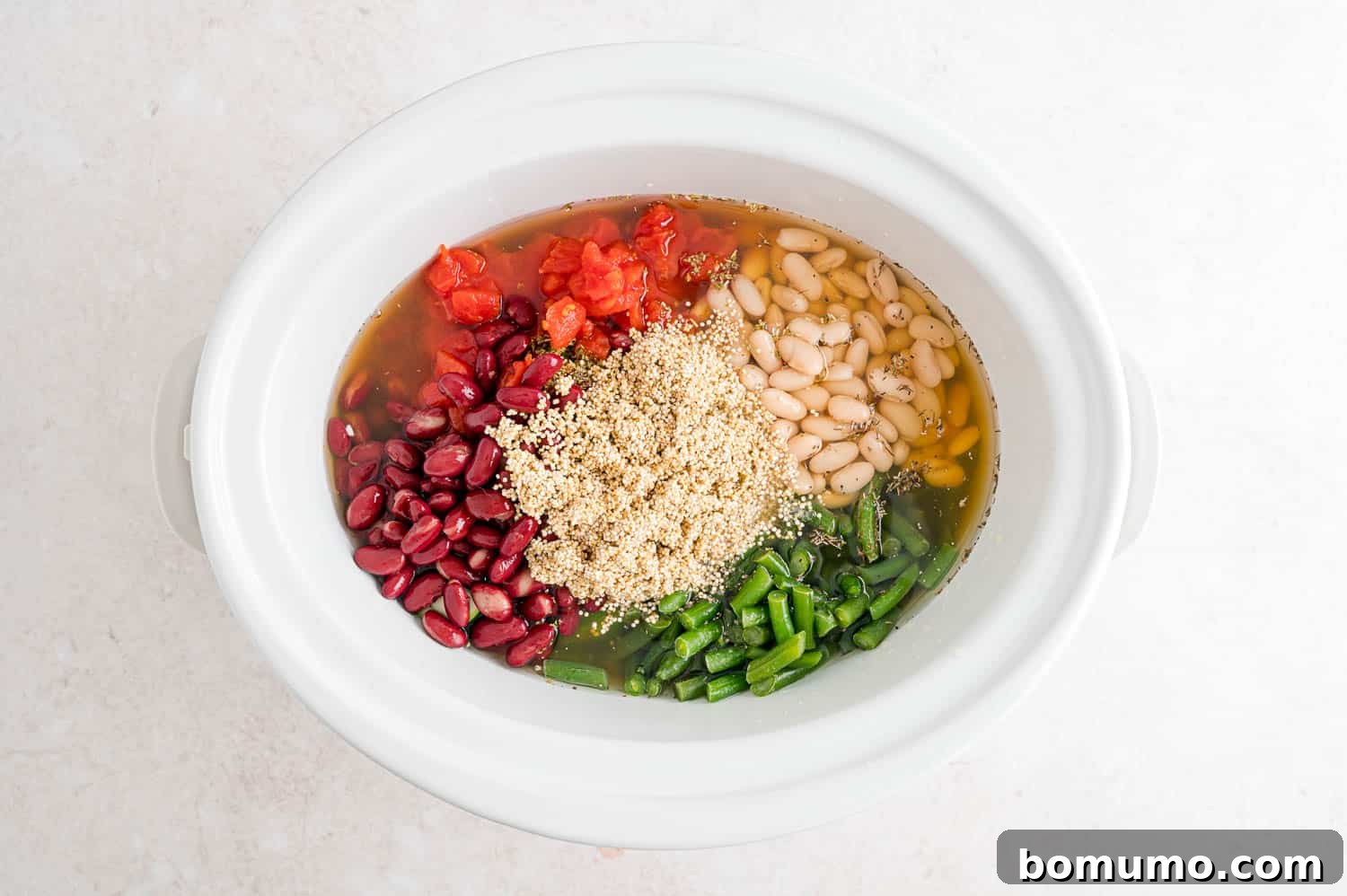 All ingredients in the crockpot, not yet stirred together.