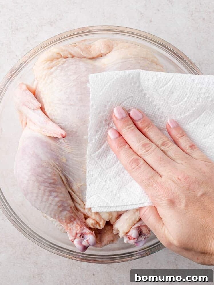 Chicken being patted dry.
