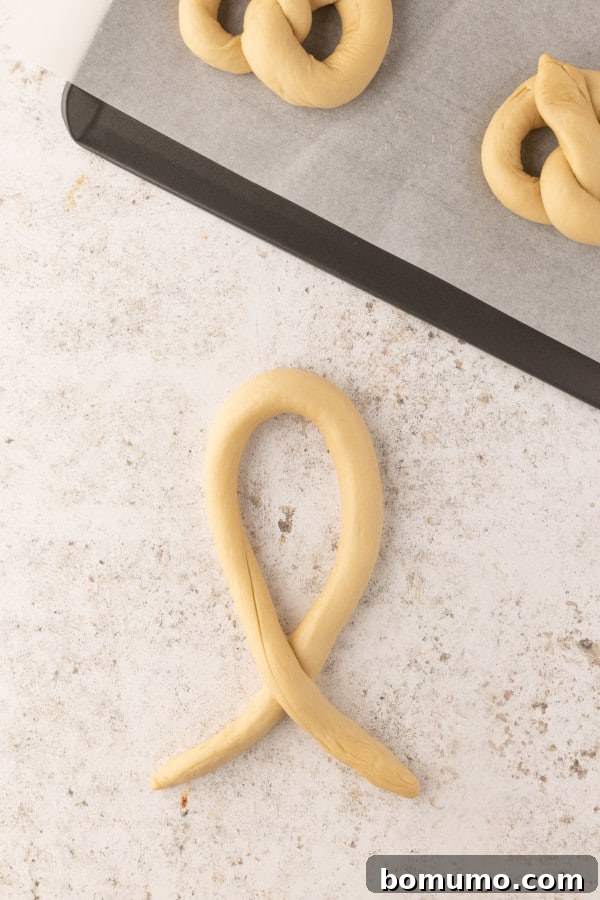 The first step in shaping a pretzel: forming the dough rope into an upside-down U.