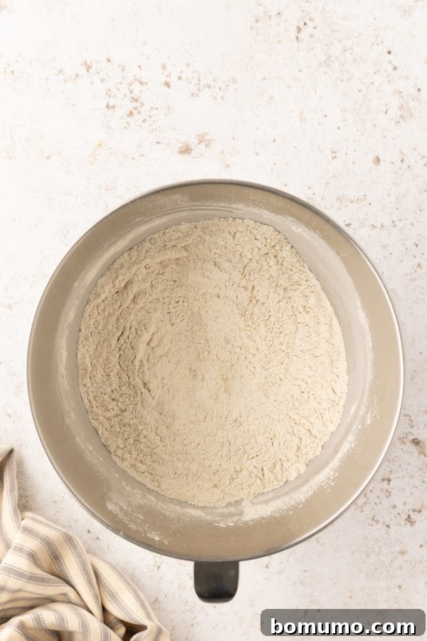 Well-combined dry ingredients in a stand mixer bowl, ready for wet ingredients.