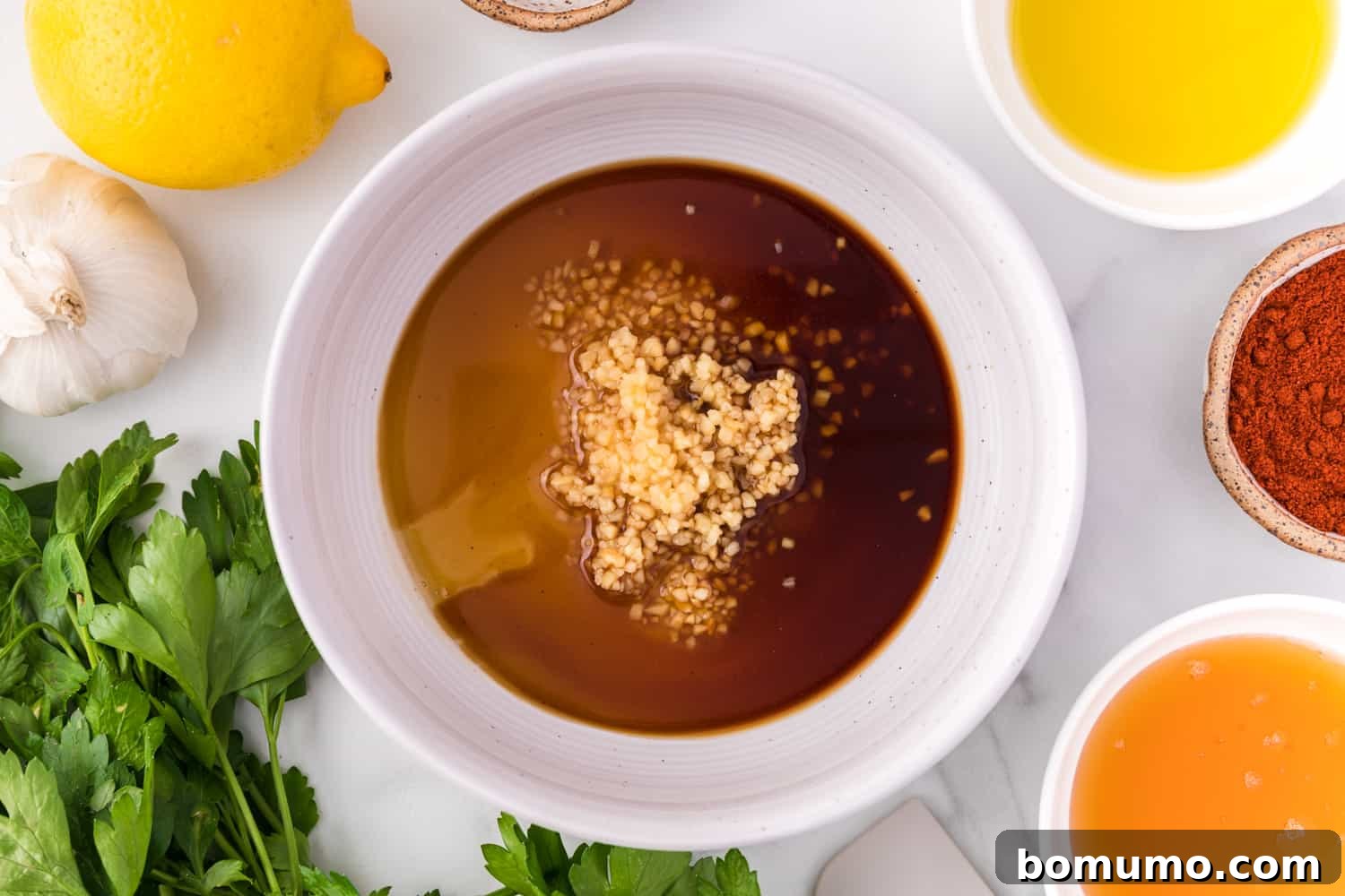 Honey garlic glaze in a small white bowl, ready for use.