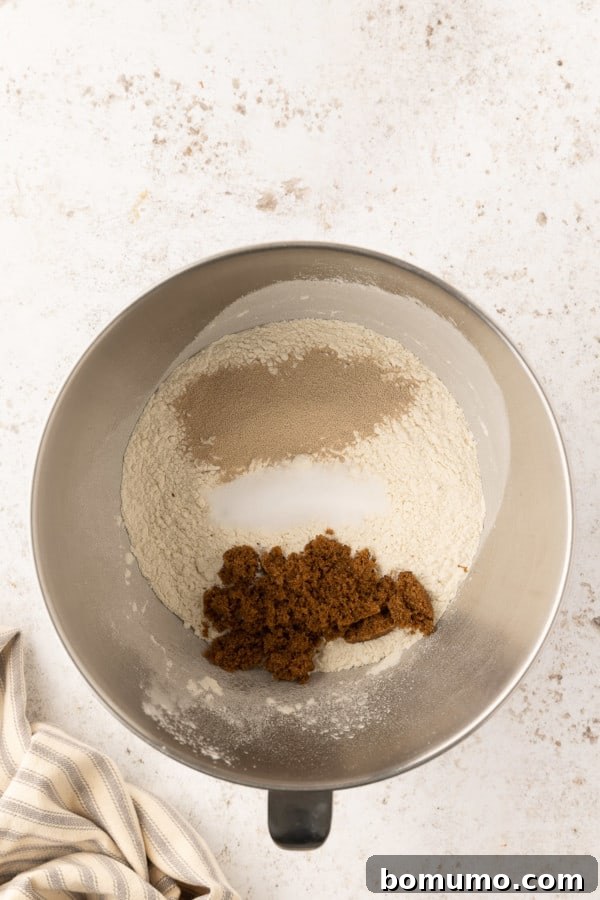 Dry pretzel dough ingredients combined in a metal bowl.