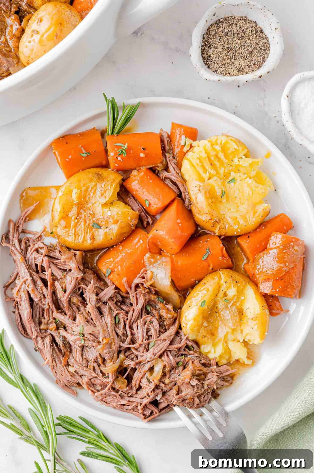 Plated pot roast with potatoes and carrots.