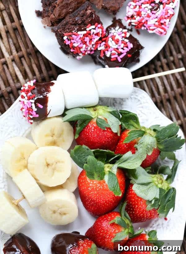 Slow Cooker Decadence 2 Delicious chocolate fondue with various dippings, including strawberries, bananas, and marshmallows.