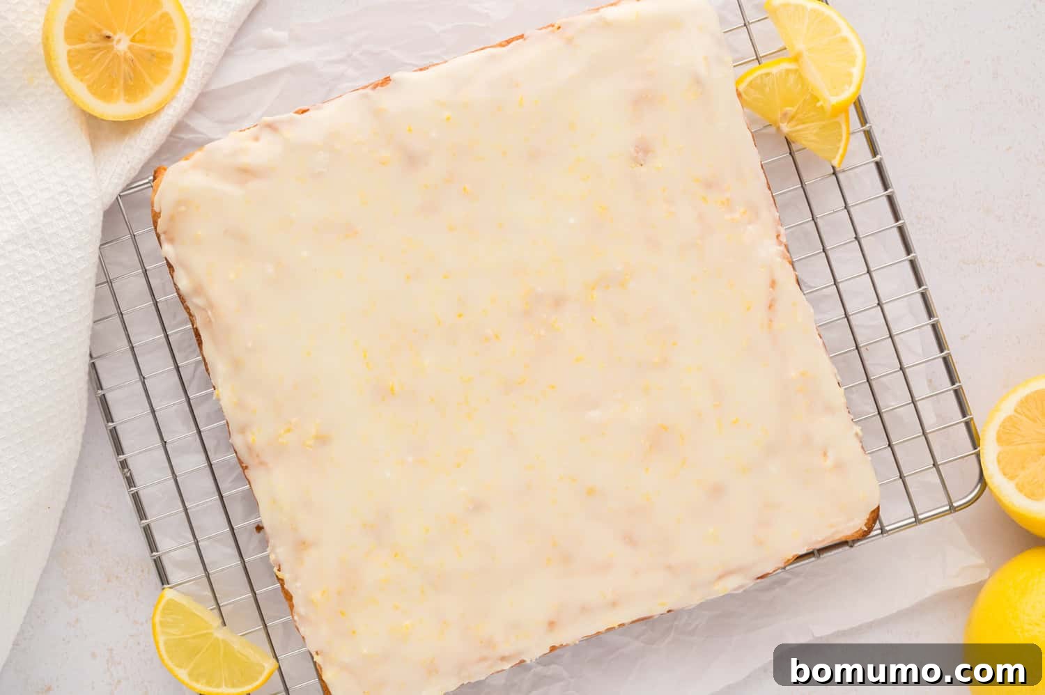 Beautifully glazed lemon brownies, still uncut, presenting a smooth and even surface.