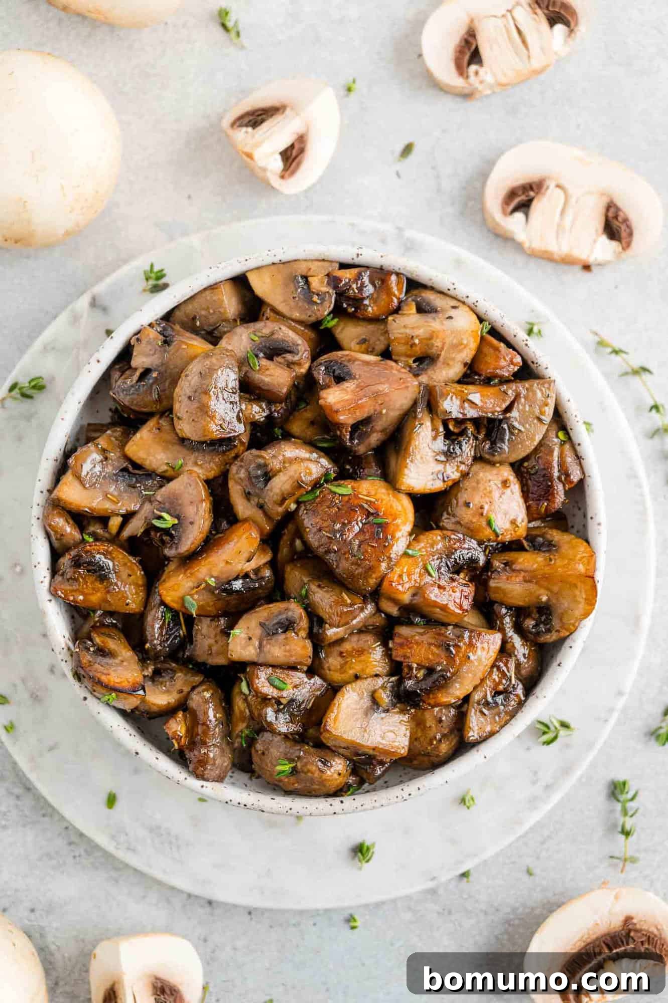 A generous serving of perfectly cooked mushrooms nestled in a large white serving bowl, ready to be enjoyed.