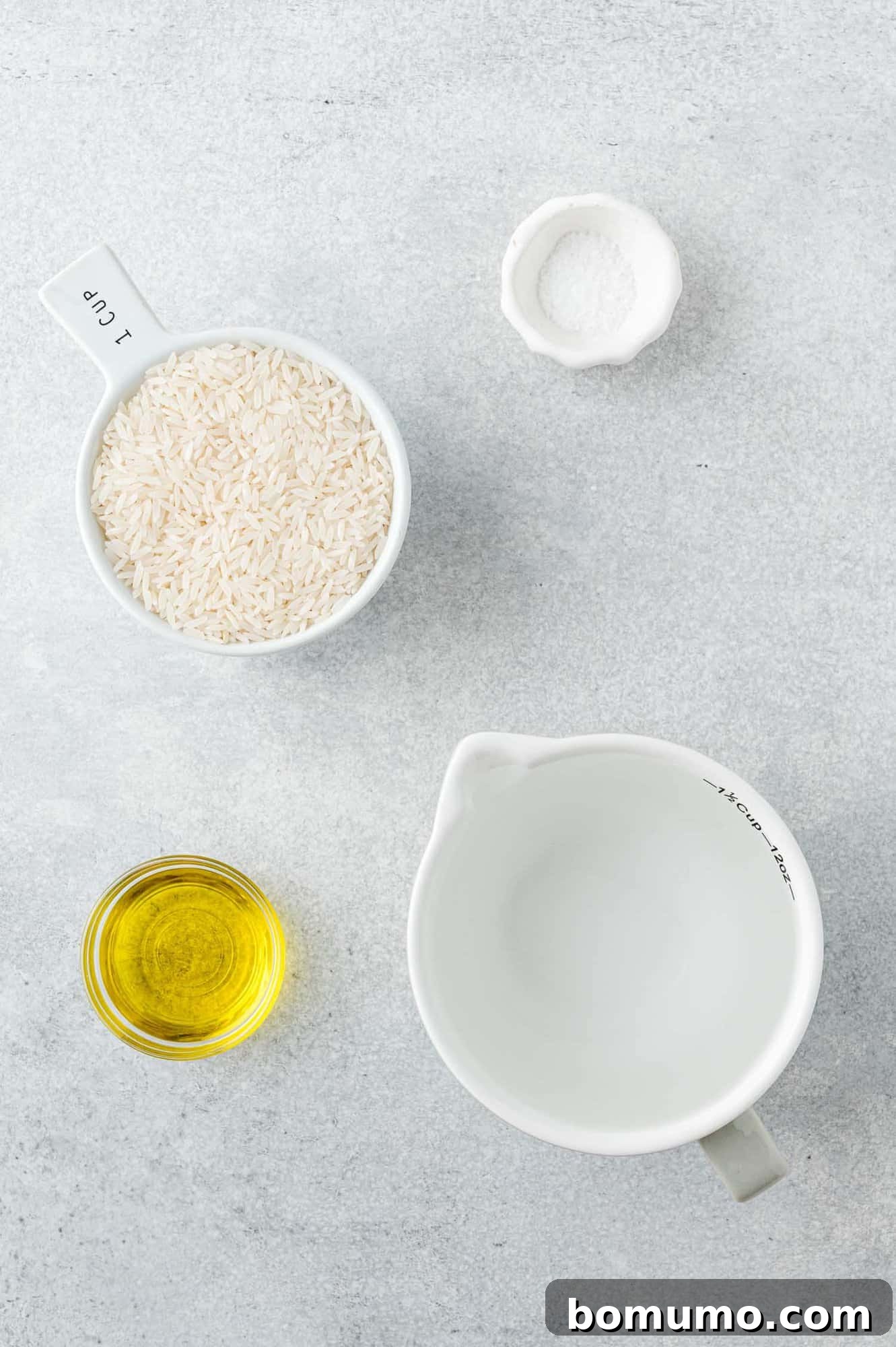 Overhead view of fresh ingredients needed for cooking jasmine rice, neatly arranged.