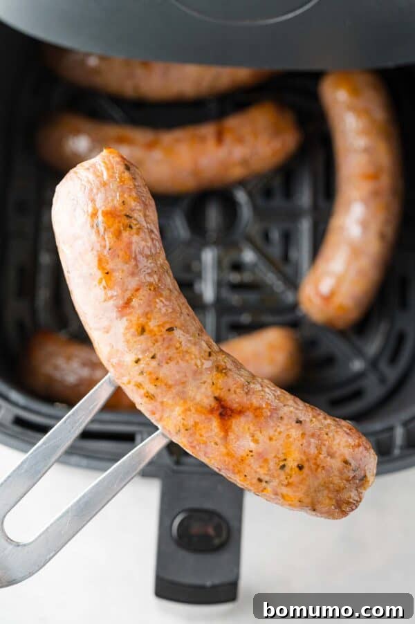 Air fryer Italian sausage on a fork.
