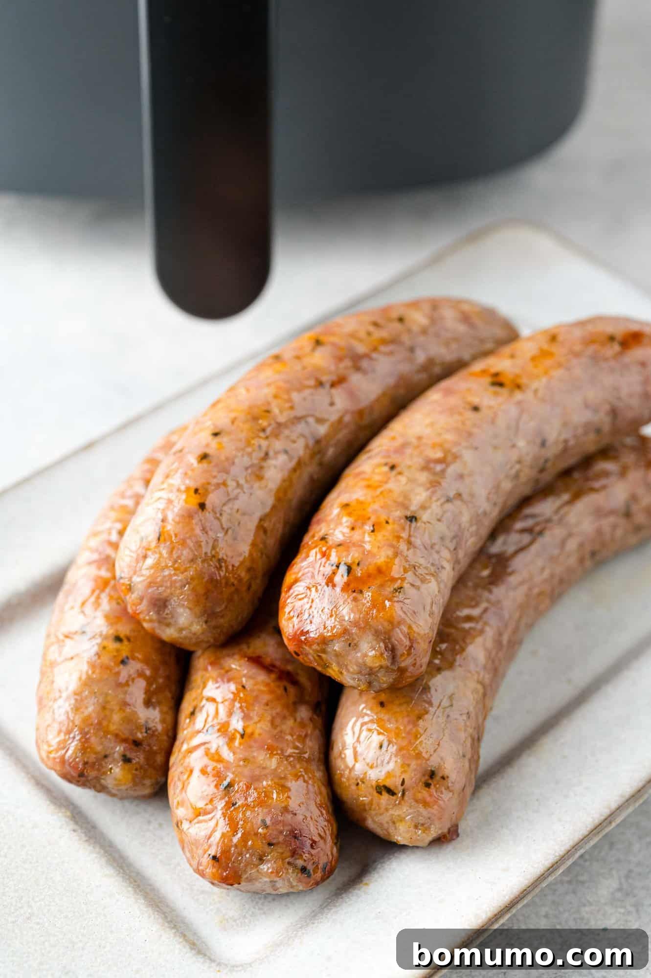 Stack of five air fryer Italian sausages.
