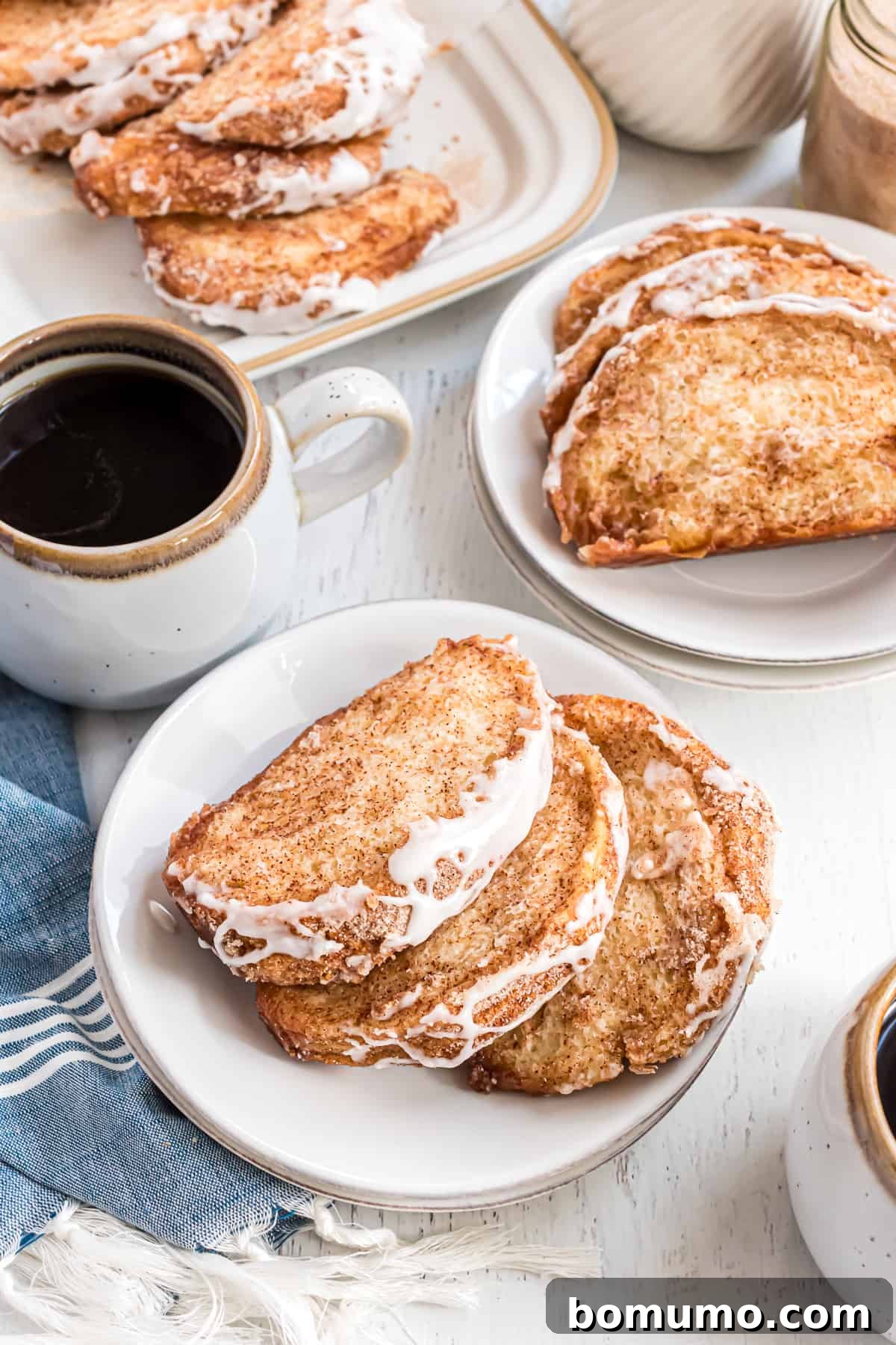 Slices of pull apart bread placed on small white plates.