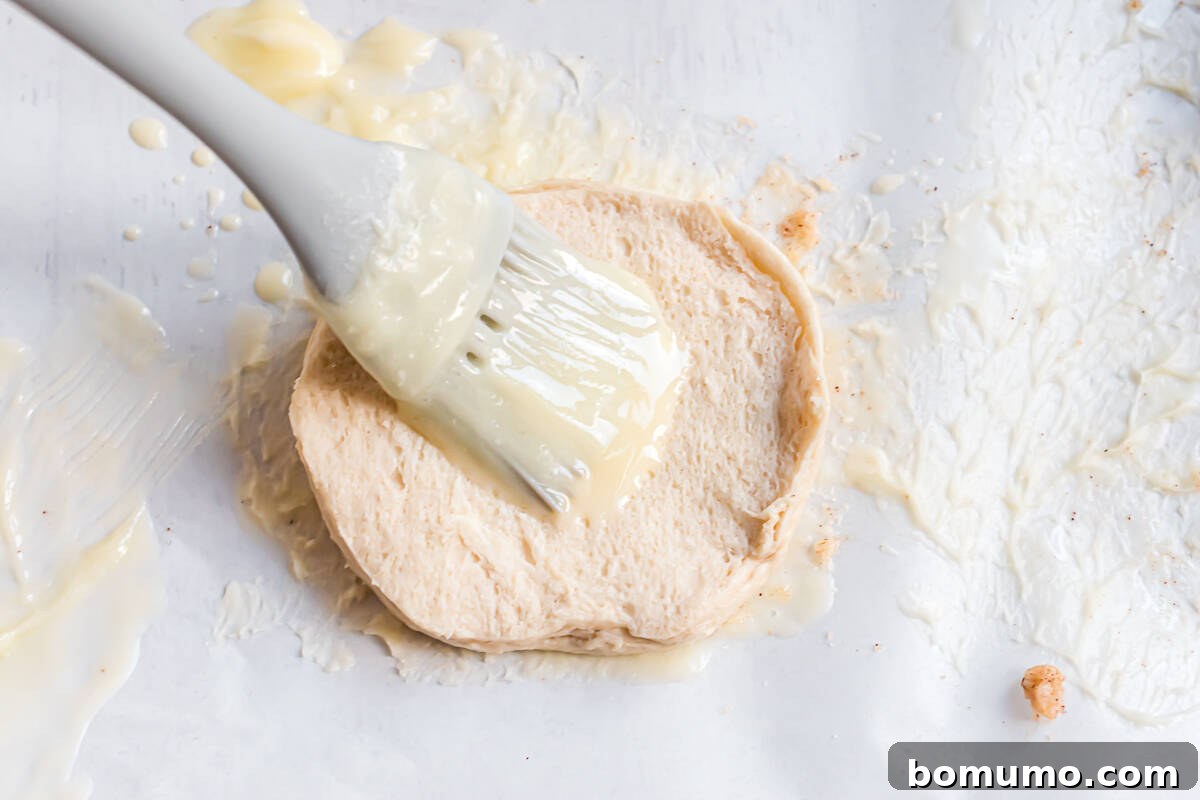 Biscuit being brushed with butter.