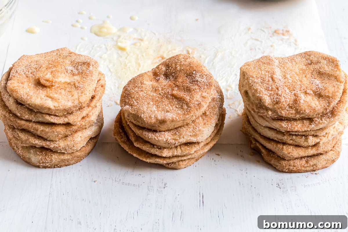 Cinnamon sugar biscuit pieces stacked in piles.