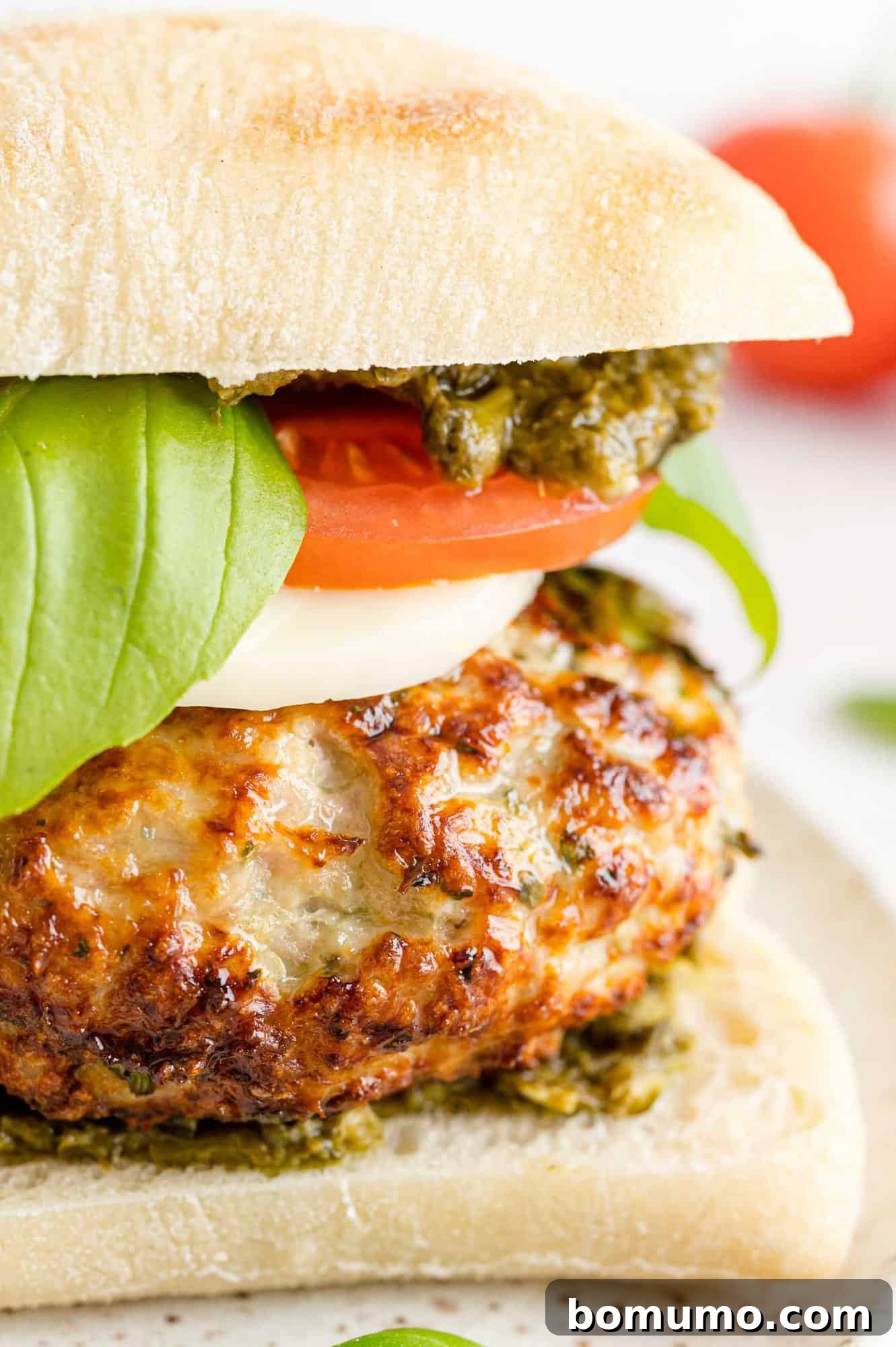 A delectable Caprese turkey burger presented on a rustic ciabatta bun, showcasing its gourmet appeal.