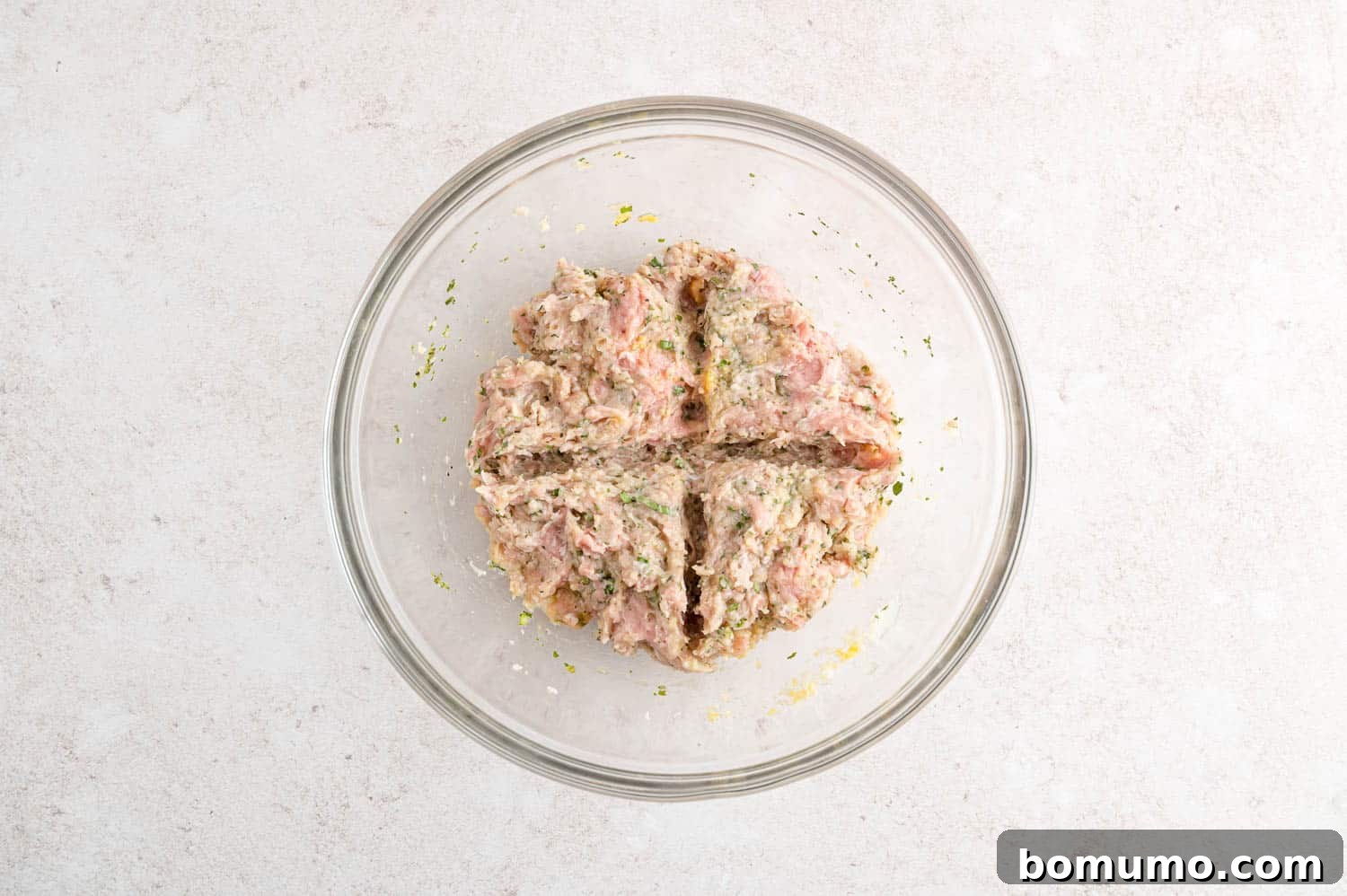 The turkey burger mixture meticulously divided into four equal portions, ready for shaping.