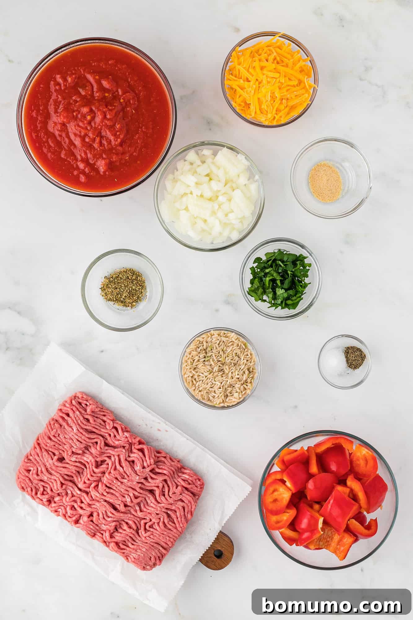 Overhead view of all the fresh and dry ingredients meticulously laid out, ready for preparing the healthy stuffed pepper casserole.