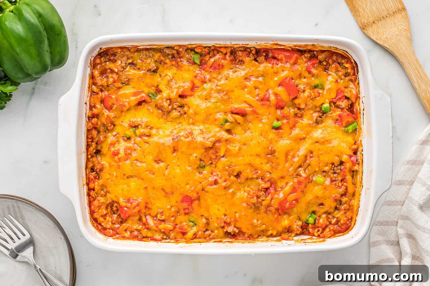 The perfectly baked stuffed pepper casserole, topped with golden, melted cheese, fresh out of the oven and ready to be served.