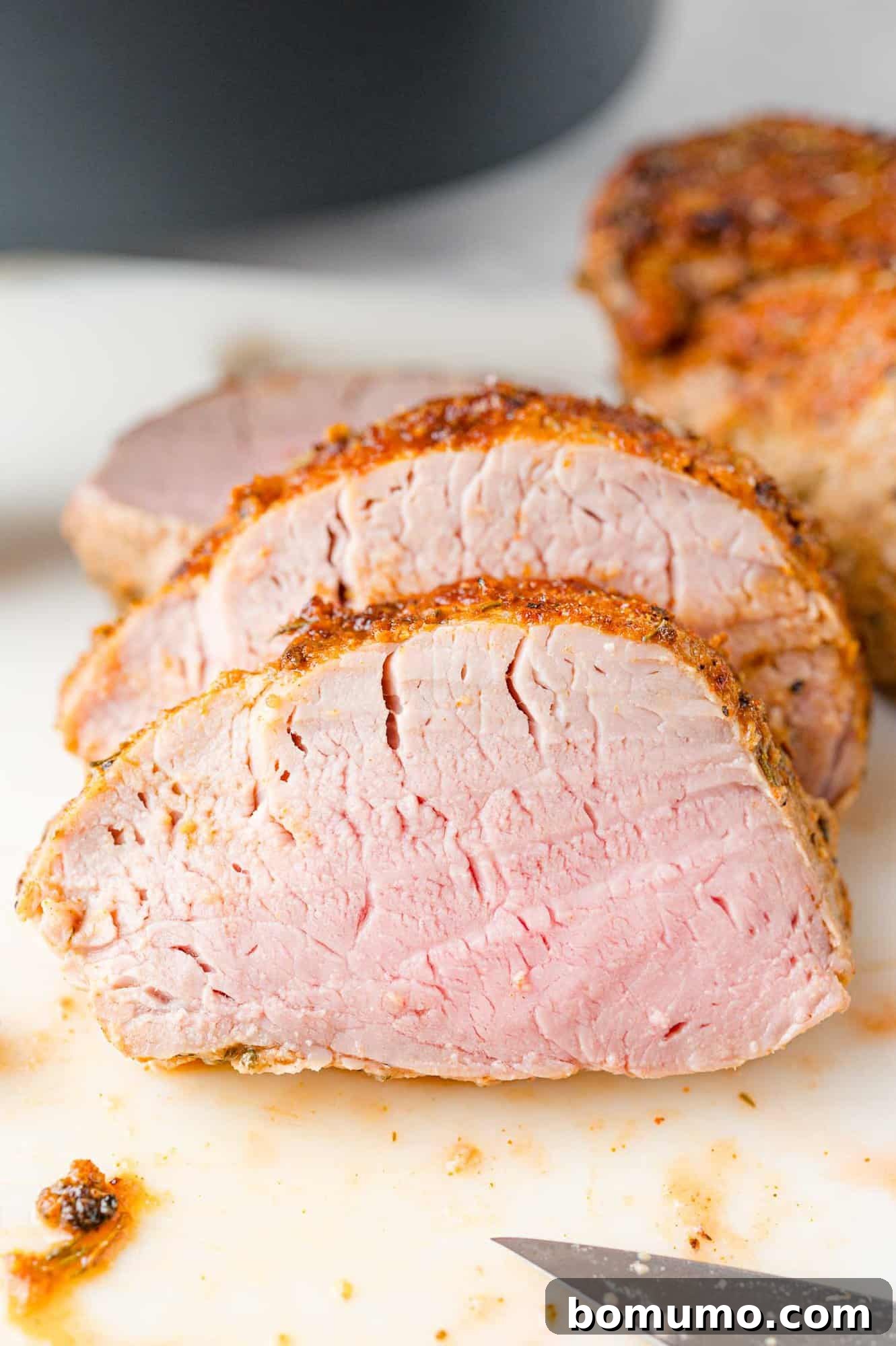 Beautifully sliced air fryer pork tenderloin medallions, ready to be served.