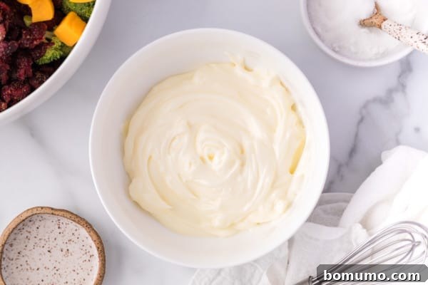 Creamy salad dressing prepared in a small white bowl.