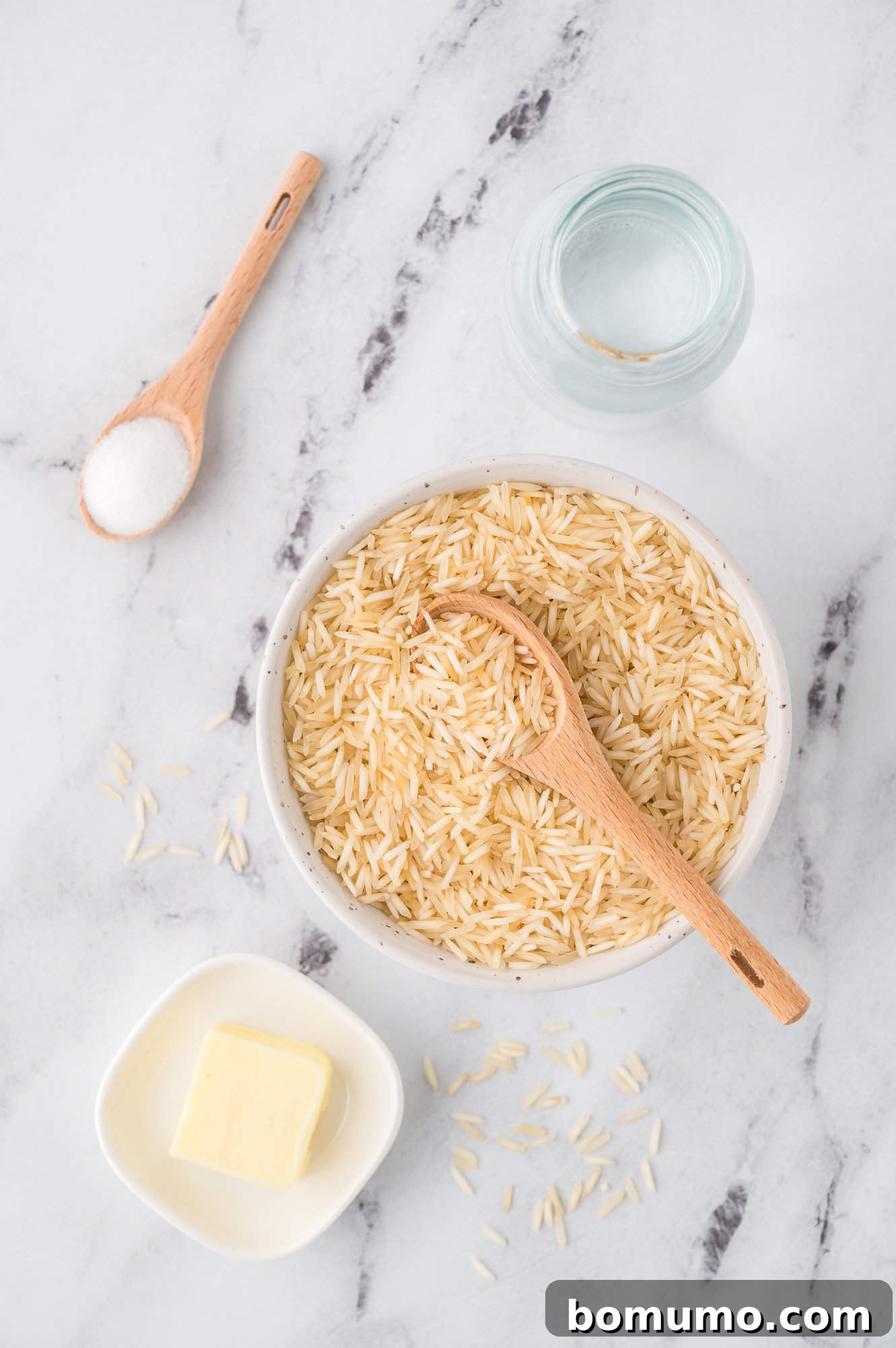 Overhead view of all ingredients needed for making Instant Pot basmati rice: basmati rice, water, oil, and kosher salt.