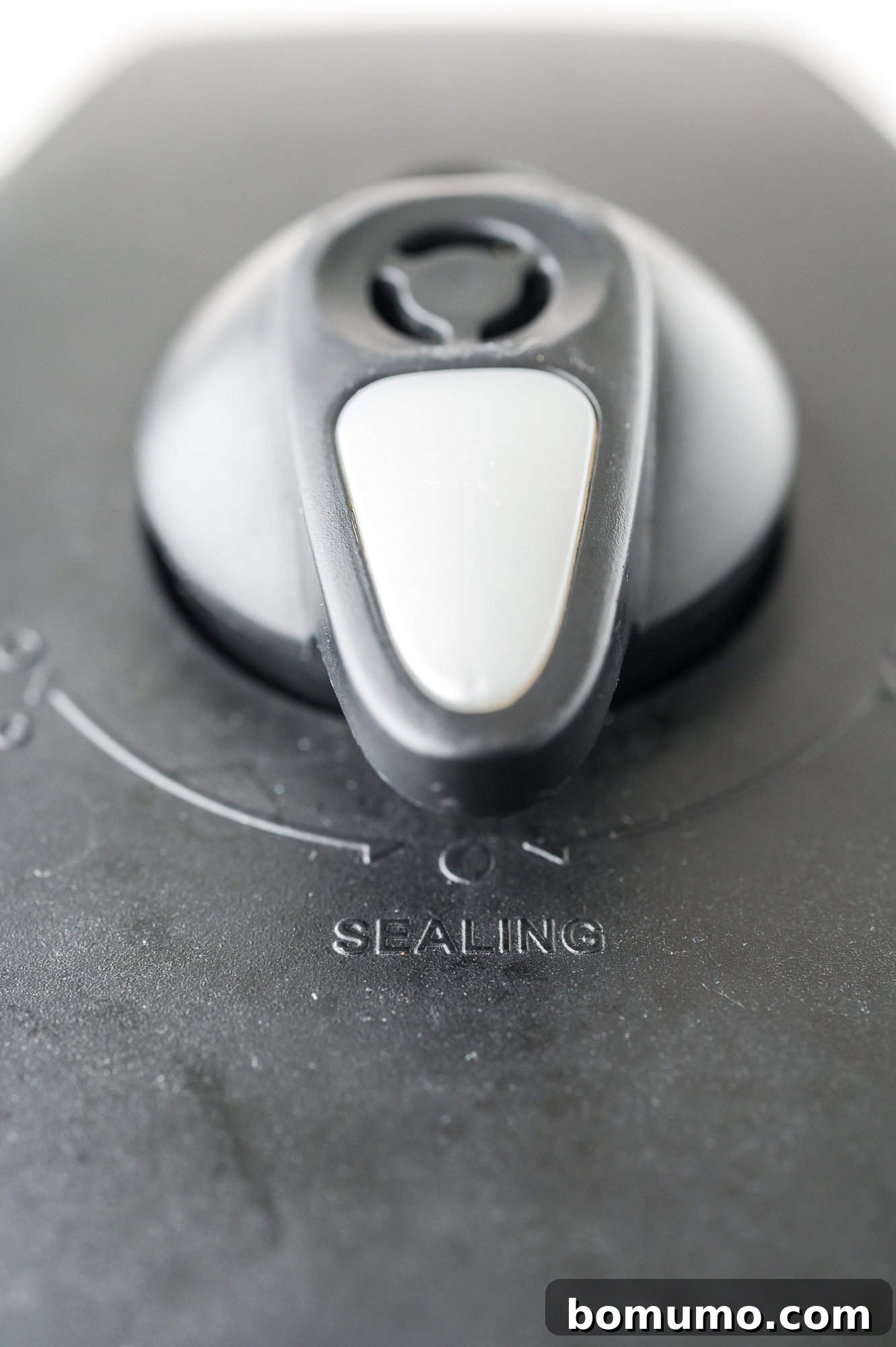 Instant Pot's steam release valve turned to the 'Sealing' position for pressure cooking.