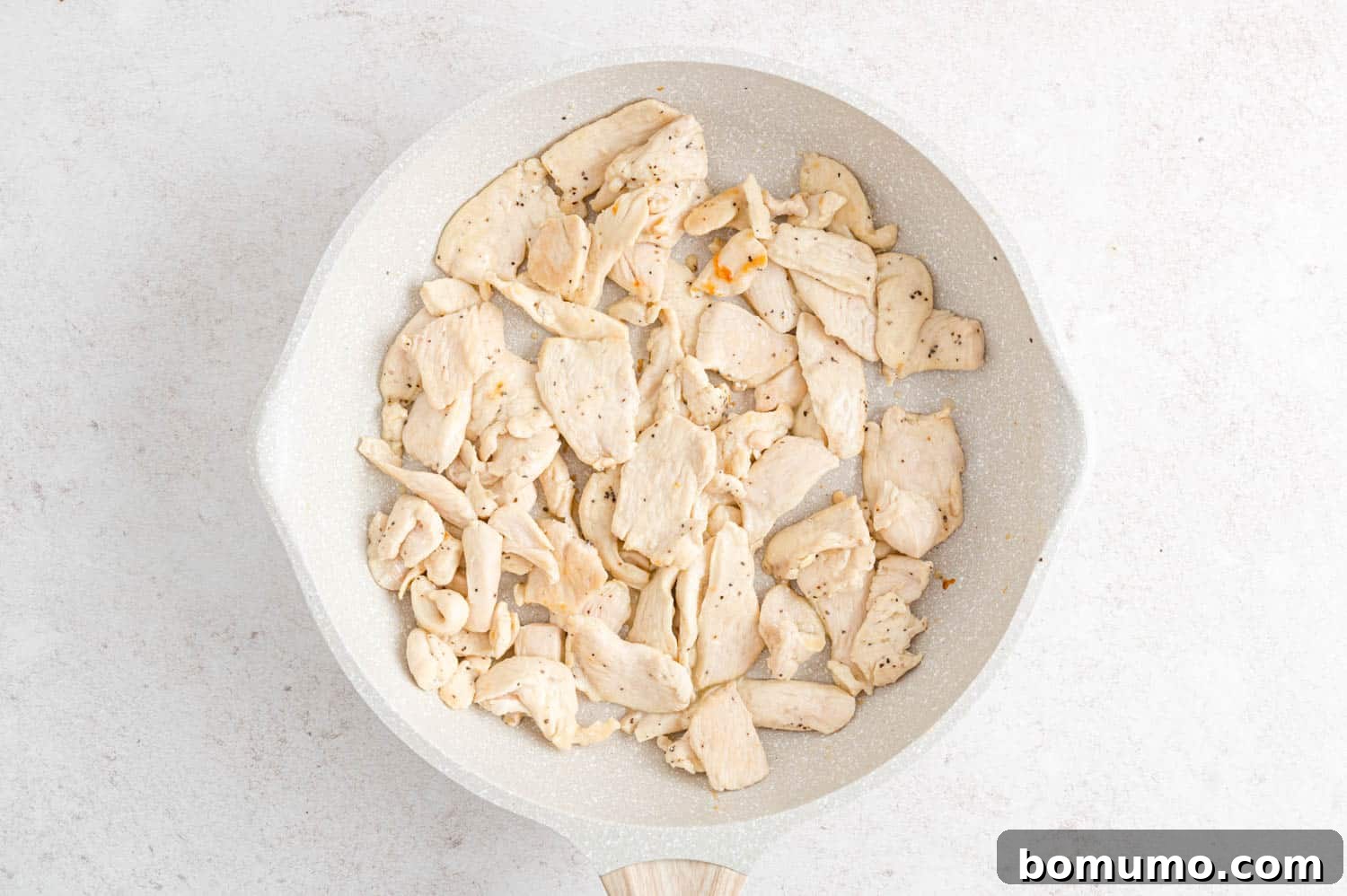 Velvety Chicken Stroganoff 5 Perfectly cooked and browned chicken pieces in a skillet.