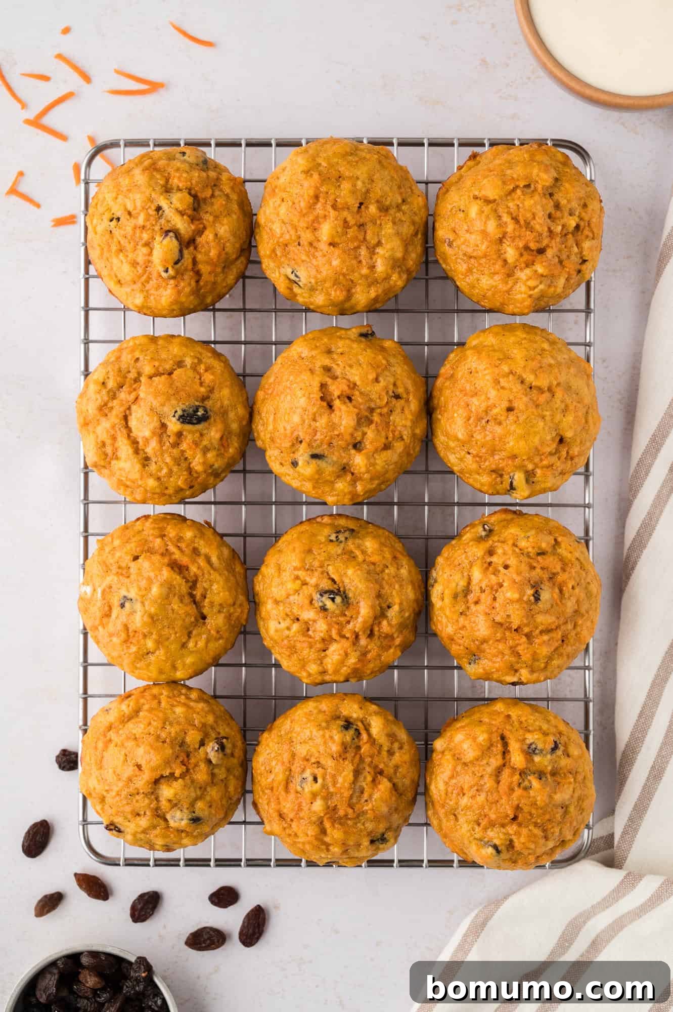Baked muffins cooling on a wire rack, allowing air circulation for a perfectly set crumb.