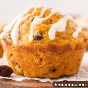 Close up view of carrot cake muffin with cream cheese glaze.