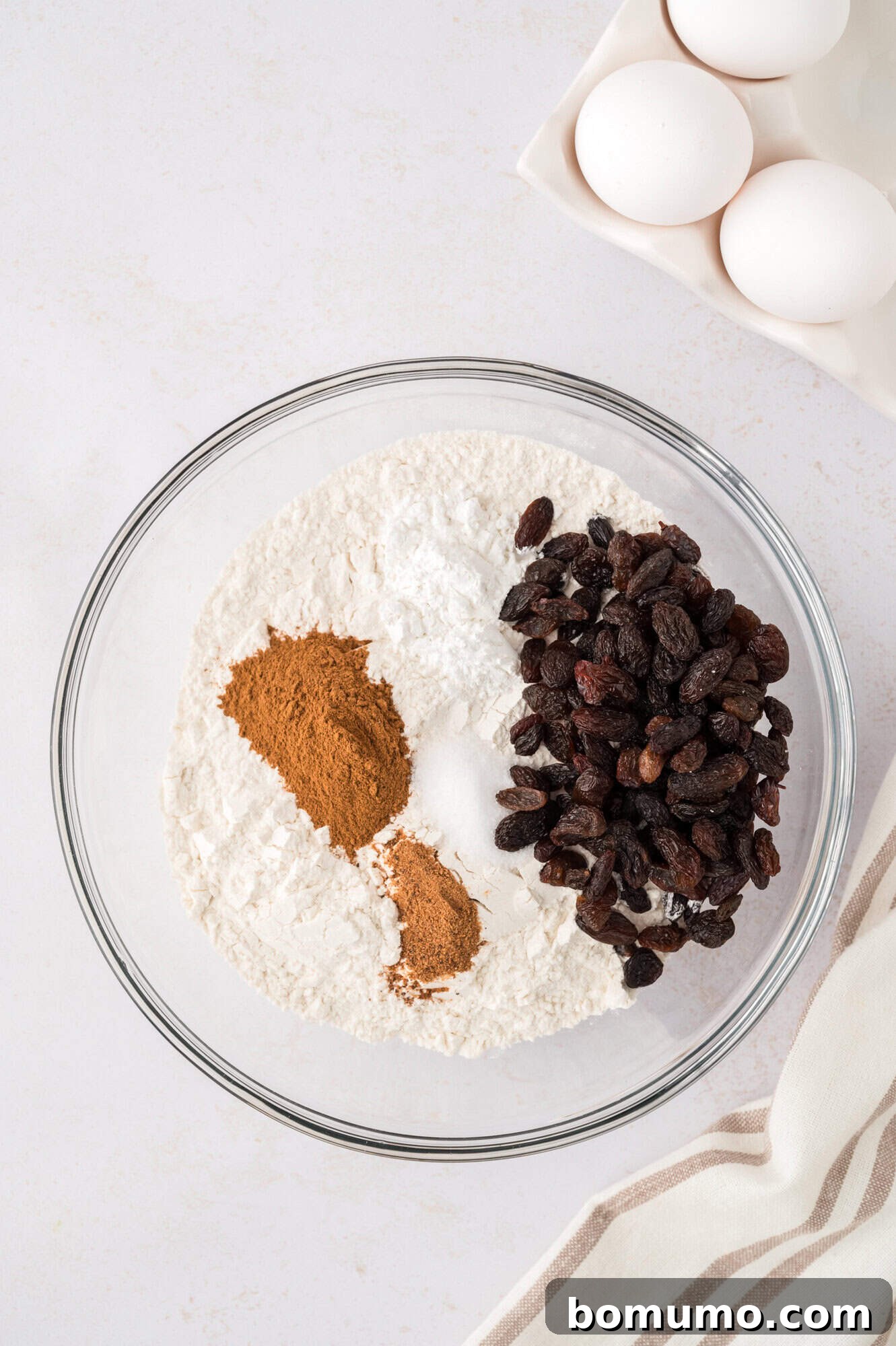 Dry ingredients in a bowl, before mixing, showing flour, spices, and leavening agents.