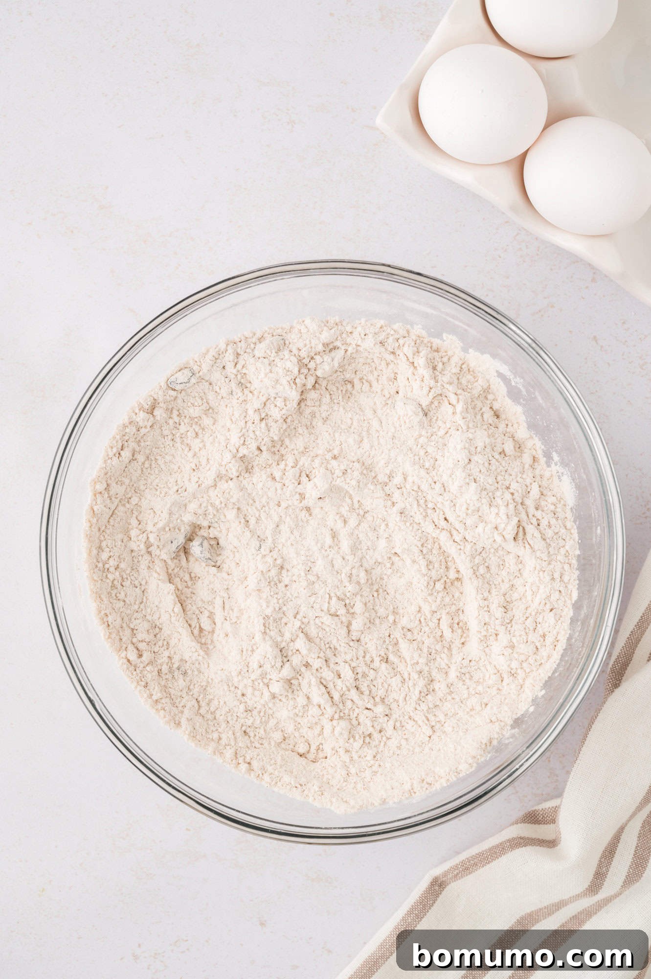 Dry ingredients in a bowl, after mixing, showing a uniform blend of flour and spices.