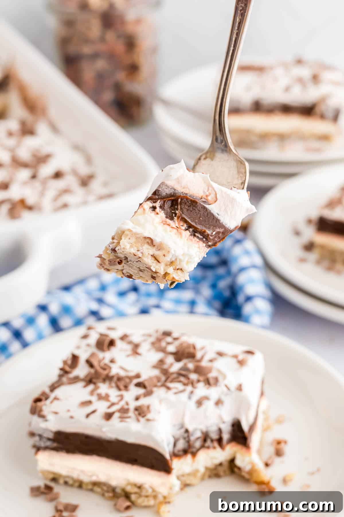 A fork holding a perfect bite of Chocolate Delight, showcasing all its distinct layers.