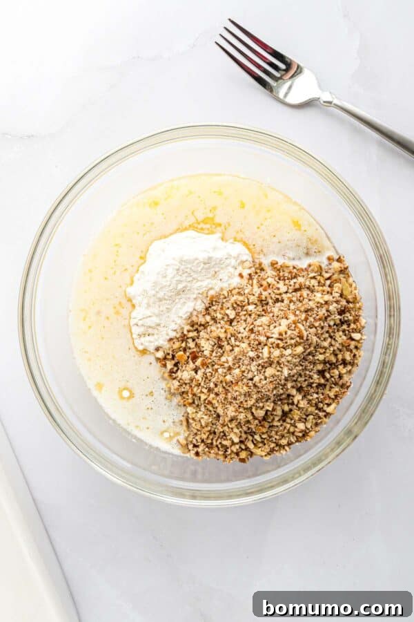 Unmixed ingredients for the pecan cookie crust: flour, melted butter, and chopped pecans in separate piles.