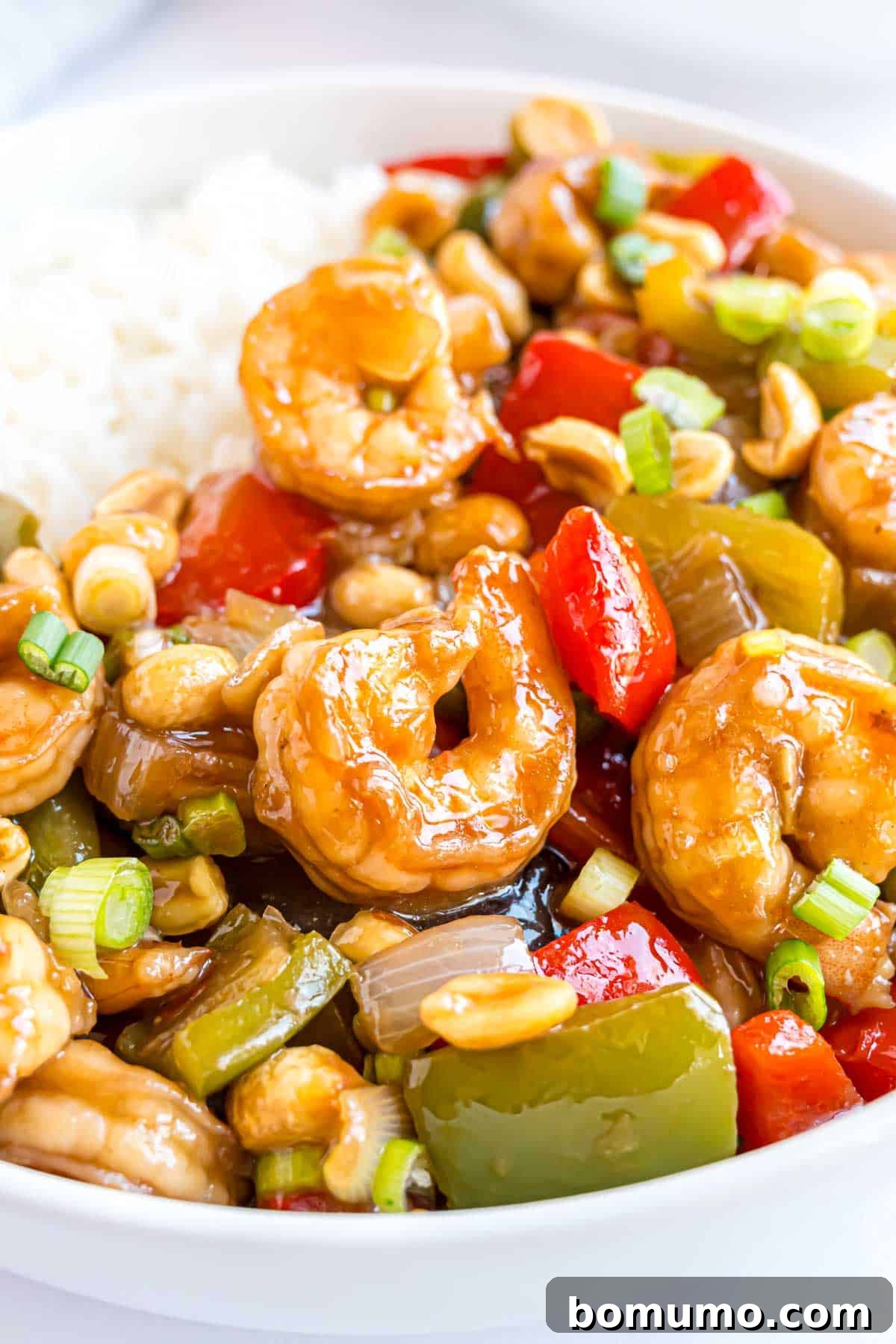 Fiery Peanut Shrimp Delight 2 Flavorful Kung Pao Shrimp served with fluffy white rice, garnished with fresh green onions for a vibrant finish.