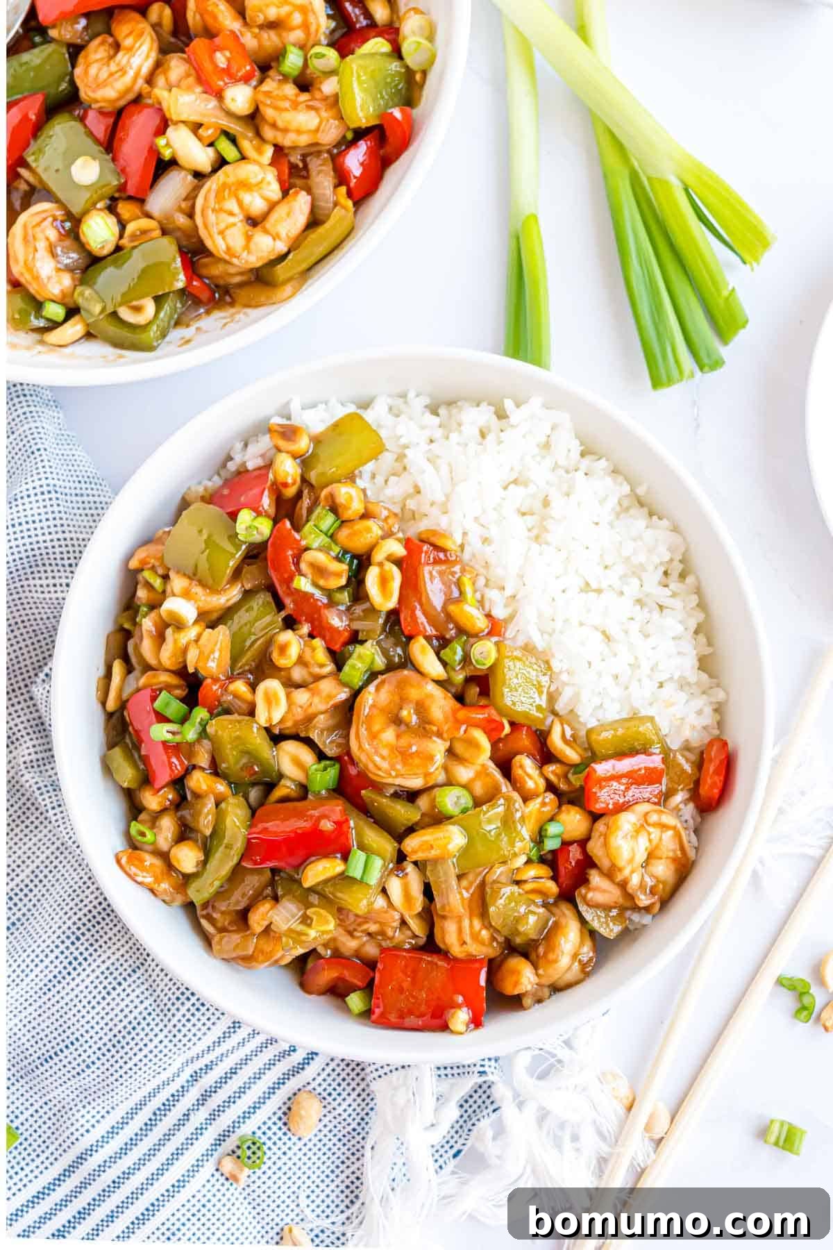 Fiery Peanut Shrimp Delight 3 Overhead view of a delectable serving of Kung Pao Shrimp, accompanied by fragrant jasmine rice, ready to be enjoyed.