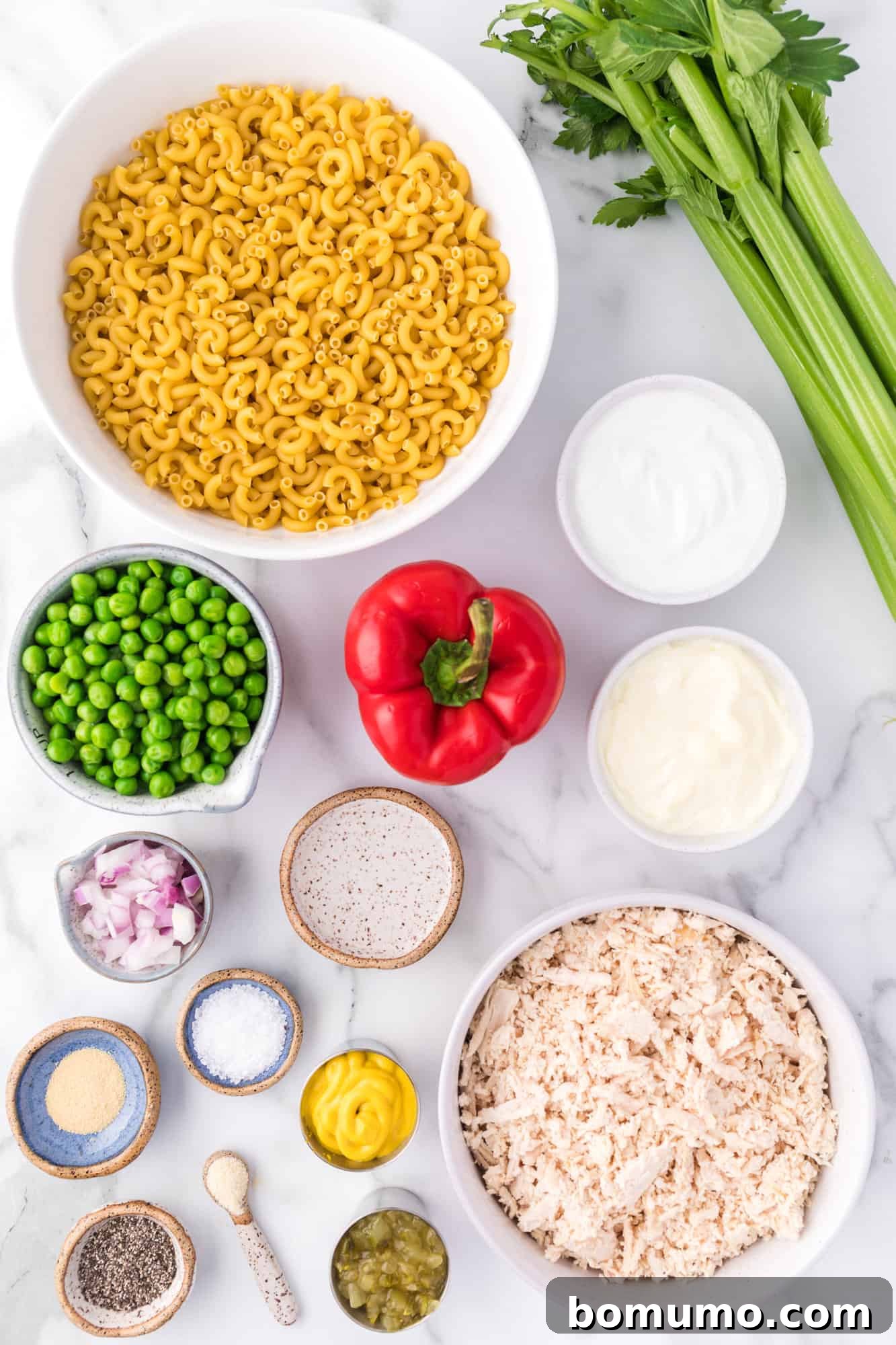 Ingredients for chicken macaroni salad laid out on a kitchen counter.