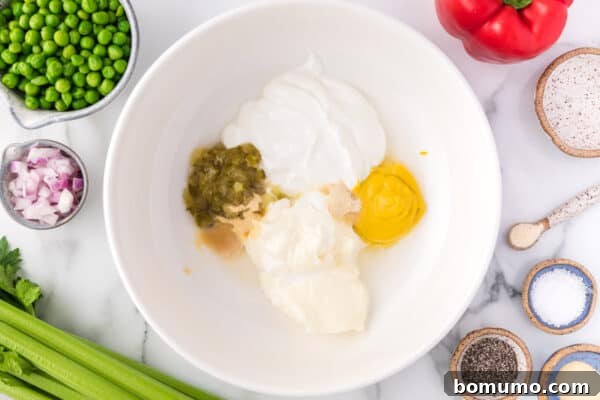 Macaroni salad dressing ingredients combined in a bowl, awaiting whisking.